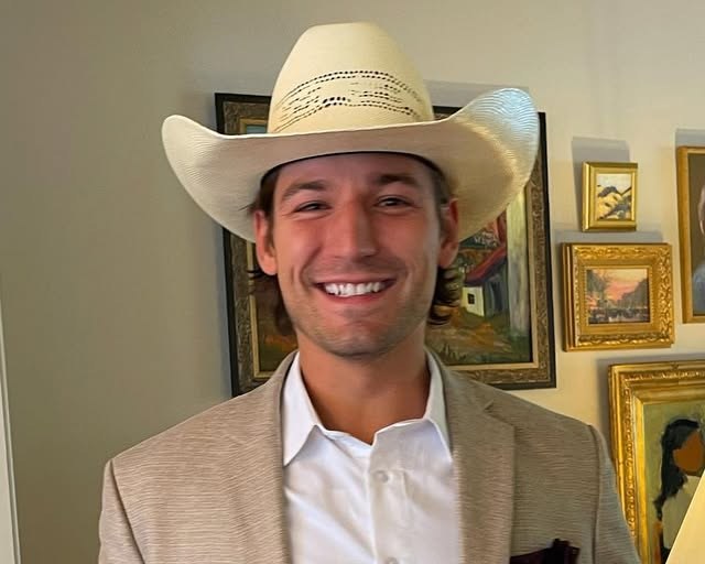 Drake in a cowboy hat and tan suit