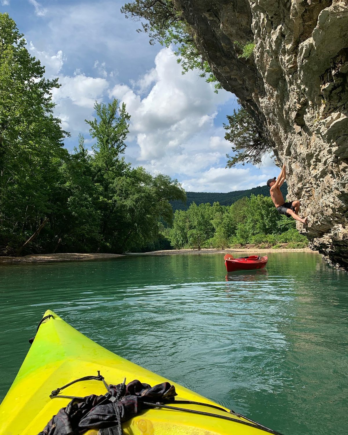 Kayak bow on the Buffalo River with a cliff jumper